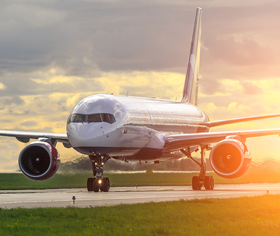 Airplane landing at sunset runway