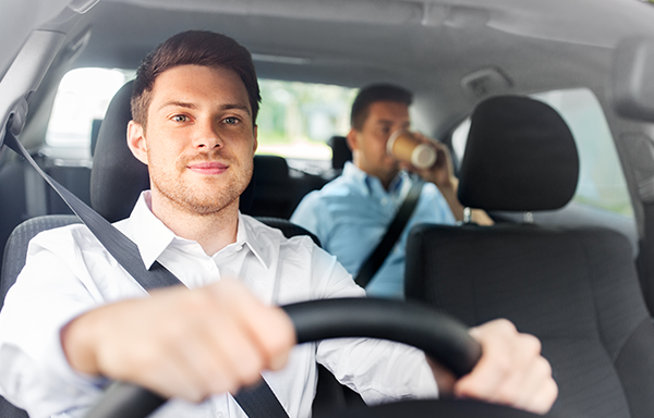 Taxi driver with passenger drinking